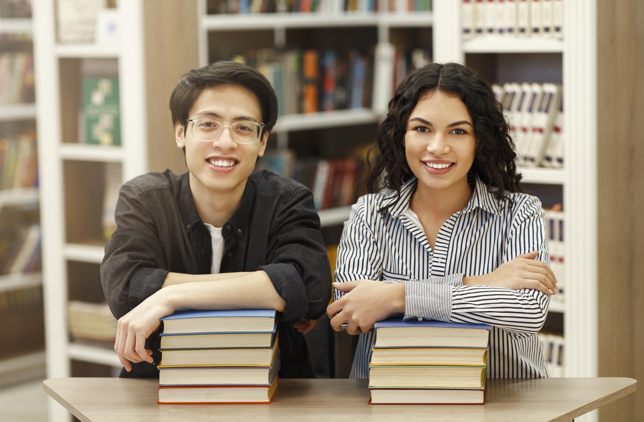 two students holding books